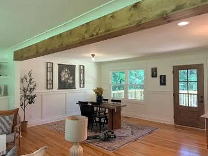 Dining room with a reclaimed timber beam and board-and-batten walls