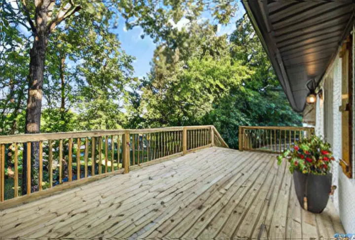 New wood deck overlooking a wooded backyard
