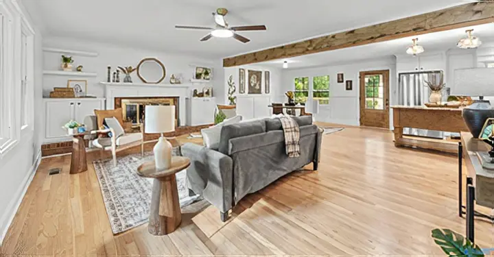 Open great room with a fireplace, built-ins and exposed beam