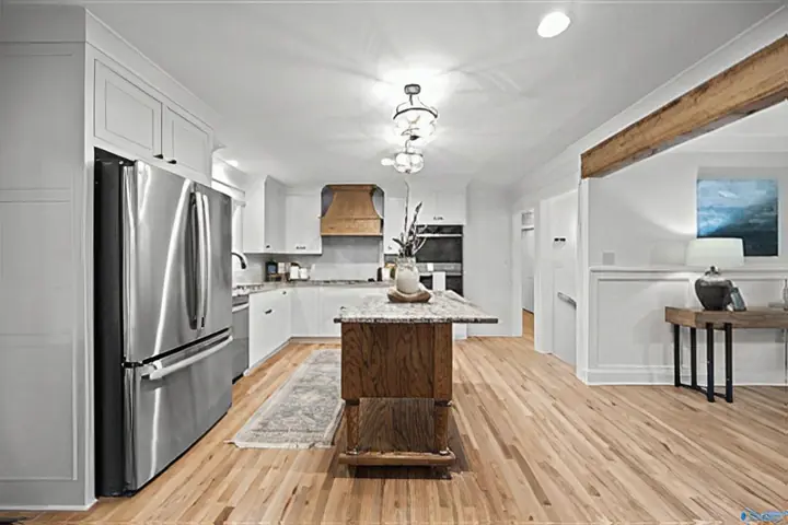 Open kitchen and dining area with a reclaimed beam