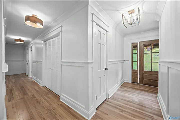 Hallway with wainscoting, new doors and trim